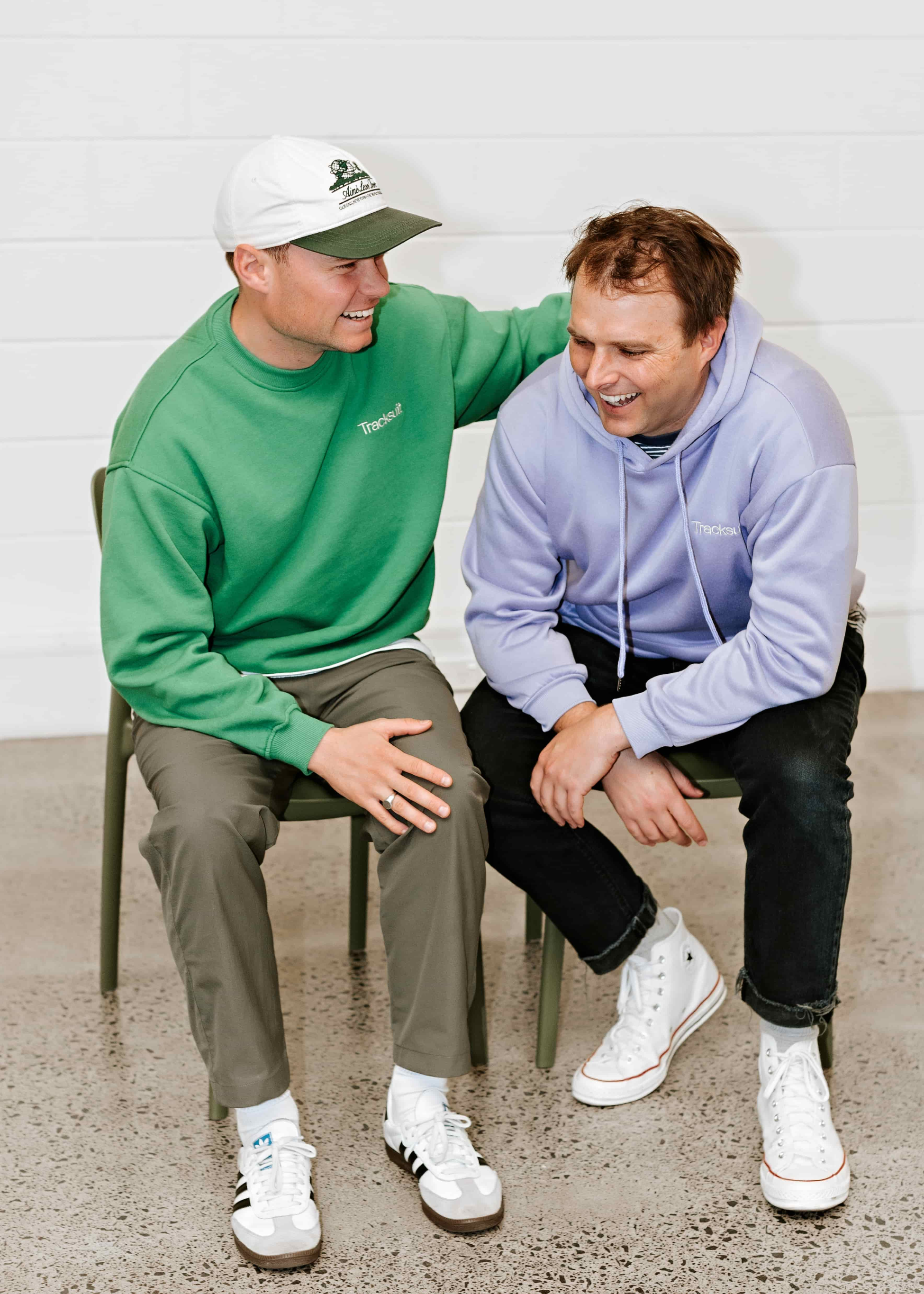 Two people wearing branded tracksuits