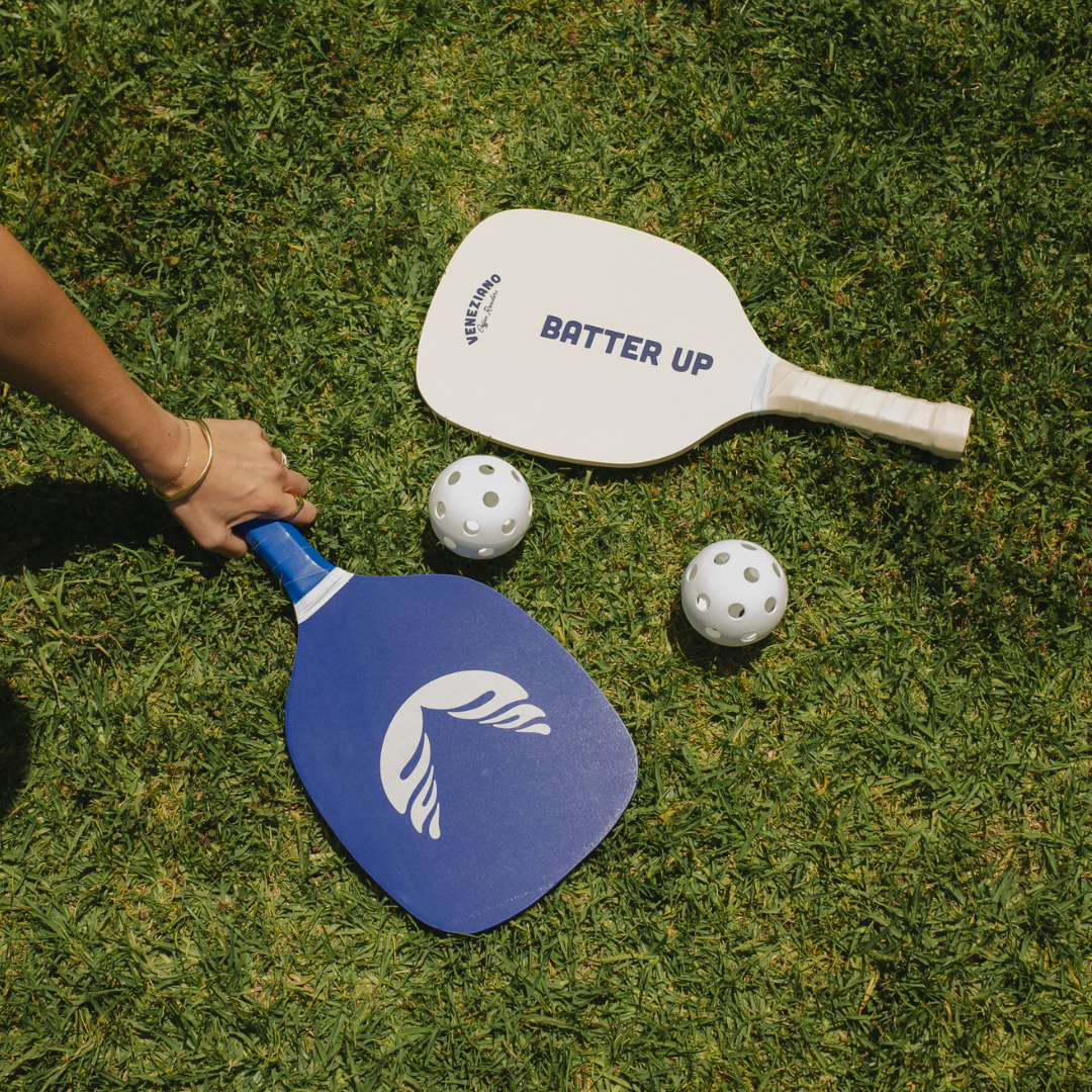 Branded pickleball paddles on grass